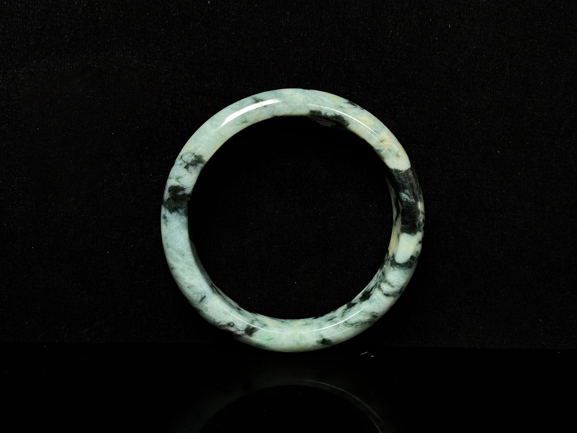 A white black jadeite bangle.