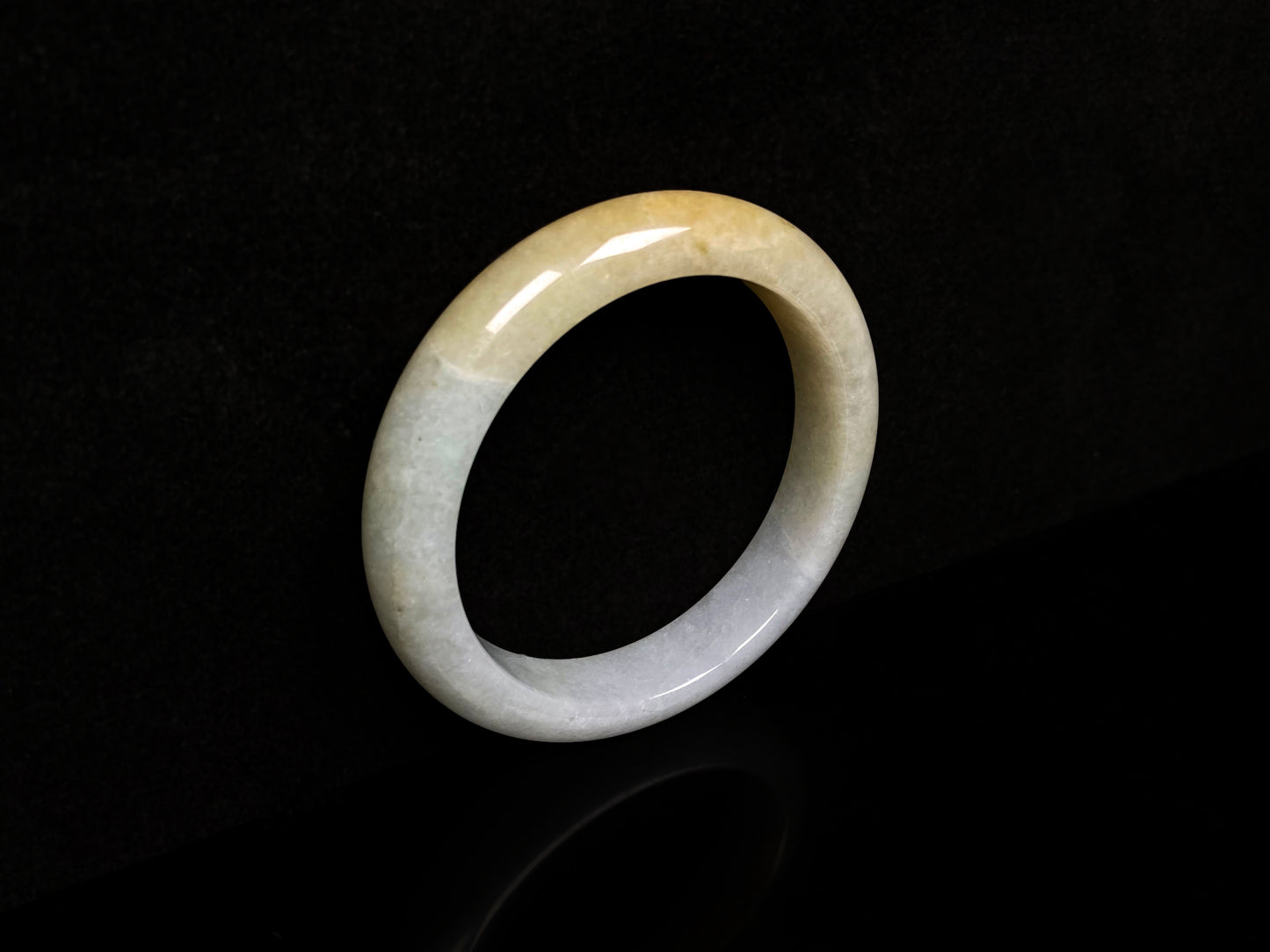 A creamy gold veil jadeite bangle.