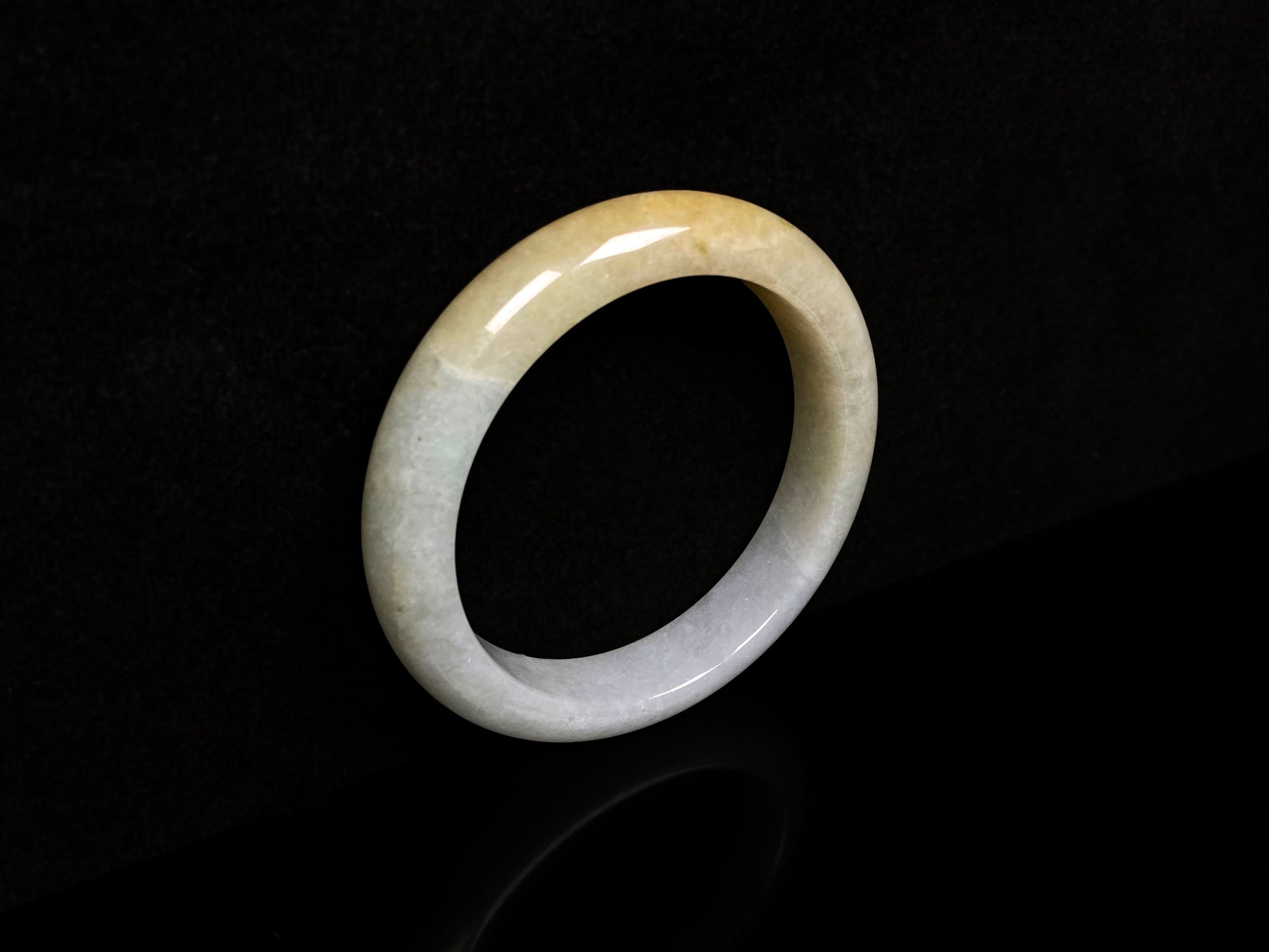 A creamy gold veil jadeite bangle.