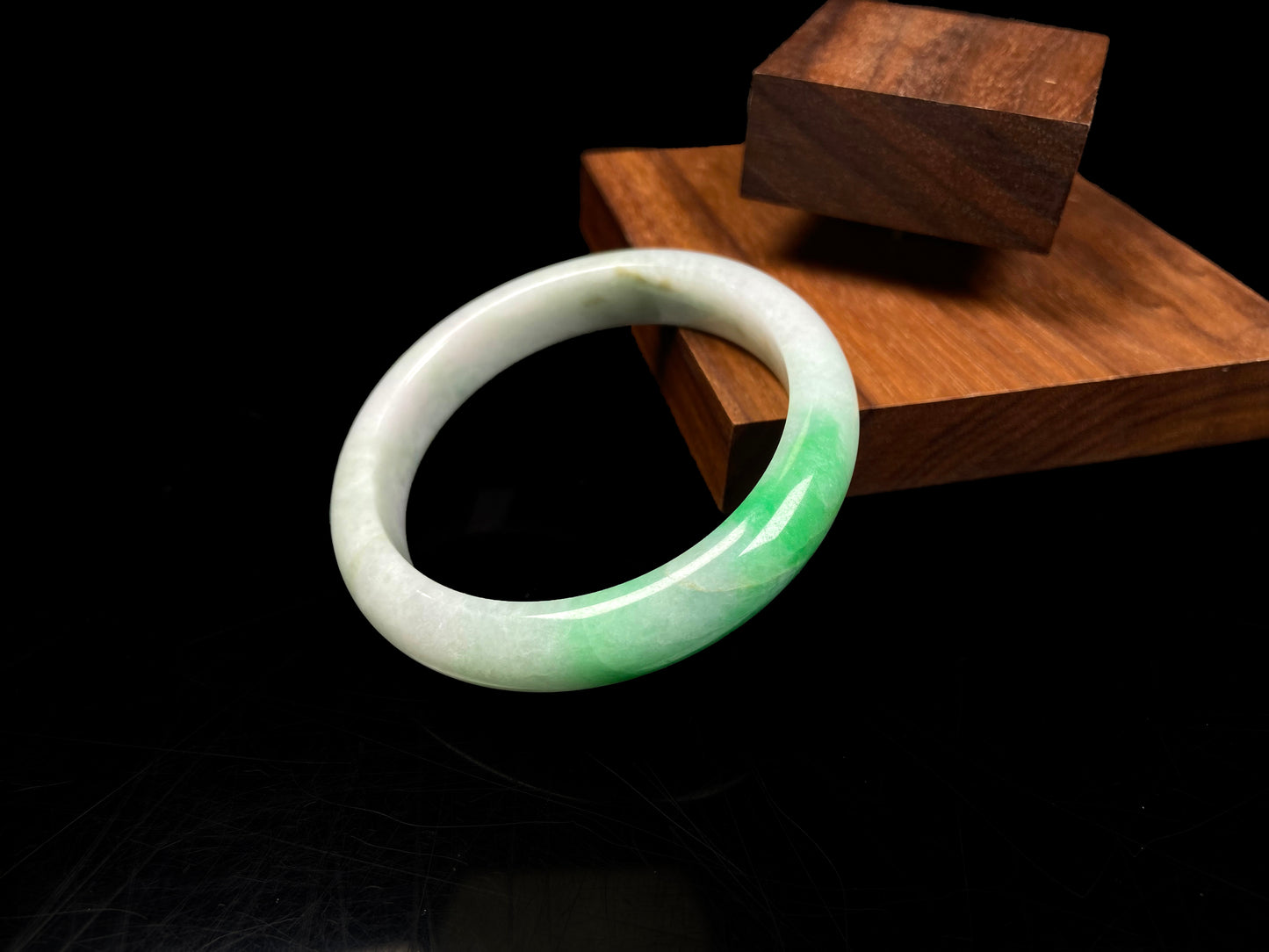 A white base with sunlit green jadeite bangle.