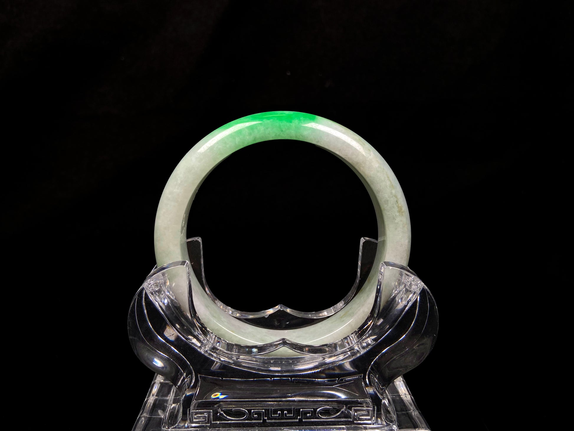 A white base with sunlit green jadeite bangle.