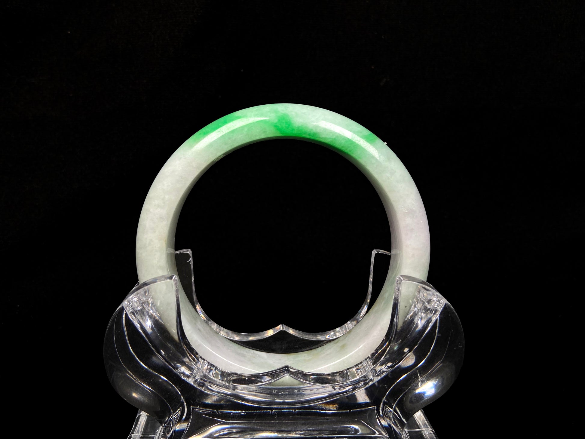 A bright green cloud white jadeite bangle.