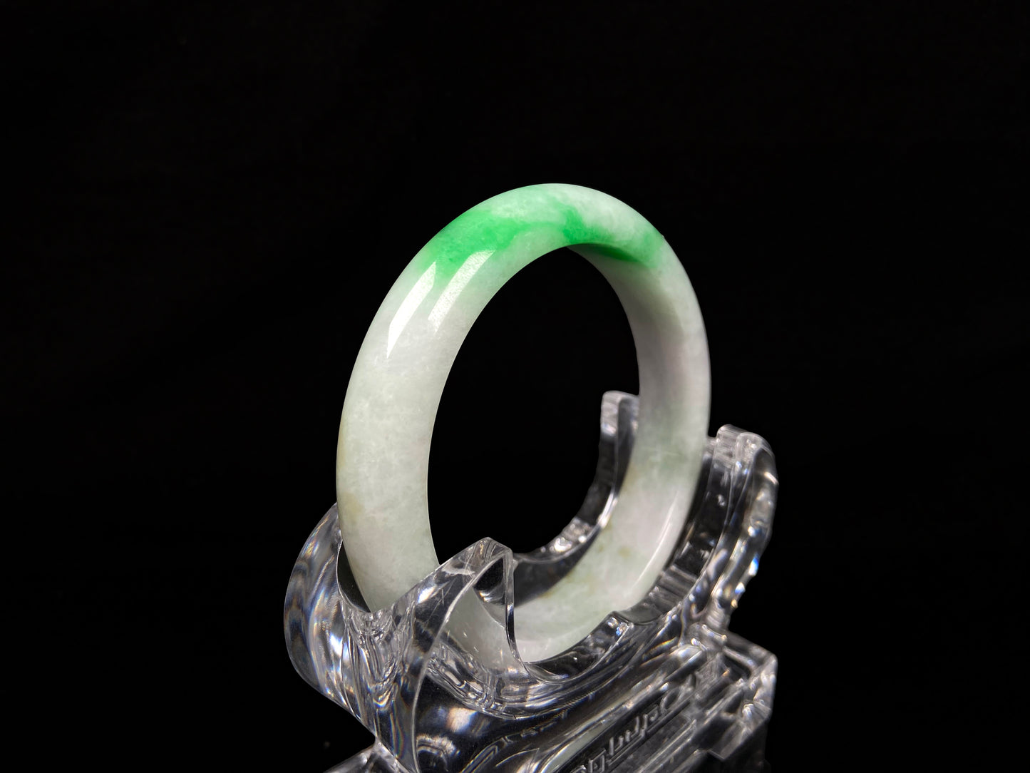 A bright green cloud white jadeite bangle.