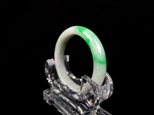 A bright green cloud white jadeite bangle.