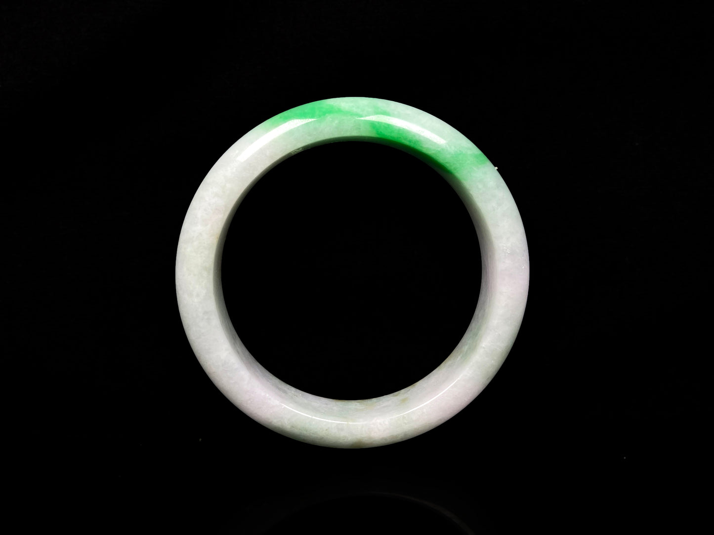 A bright green cloud white jadeite bangle.