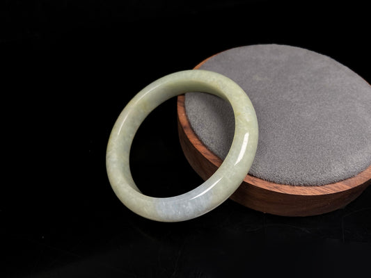 A golden glow spill jadeite bangle.