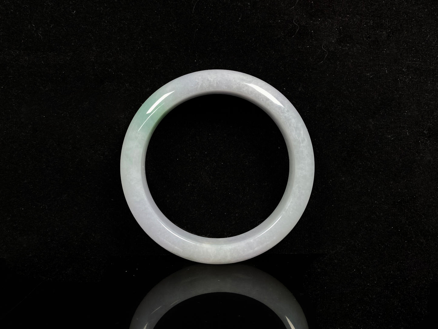 A violet white with green jadeite bangle.