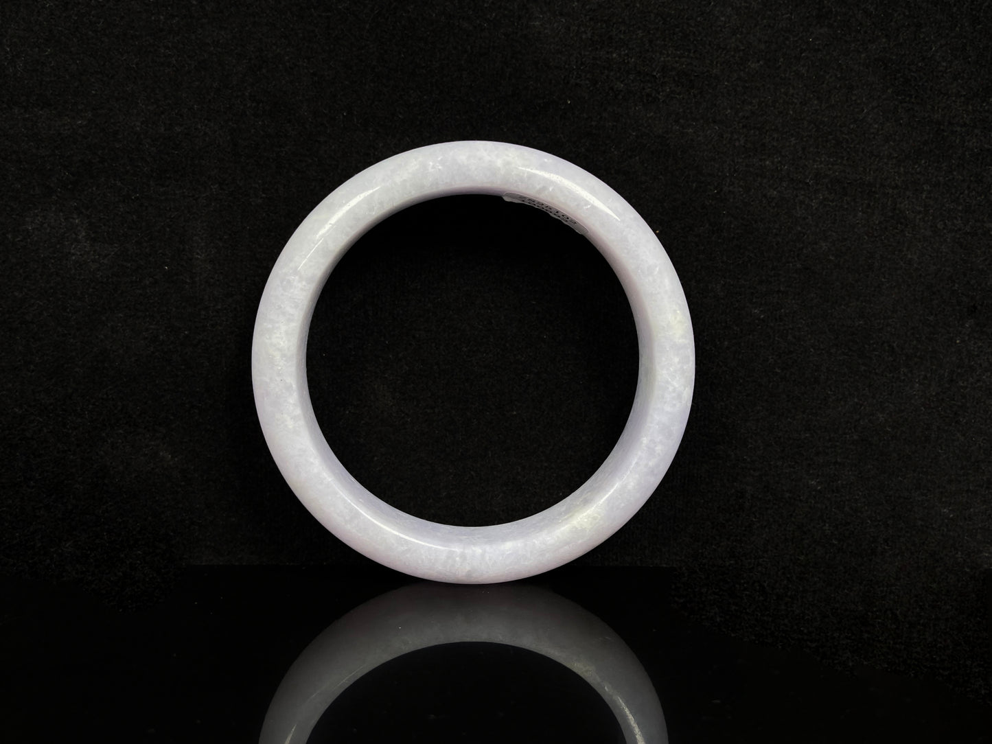 A violet white jadeite bangle.