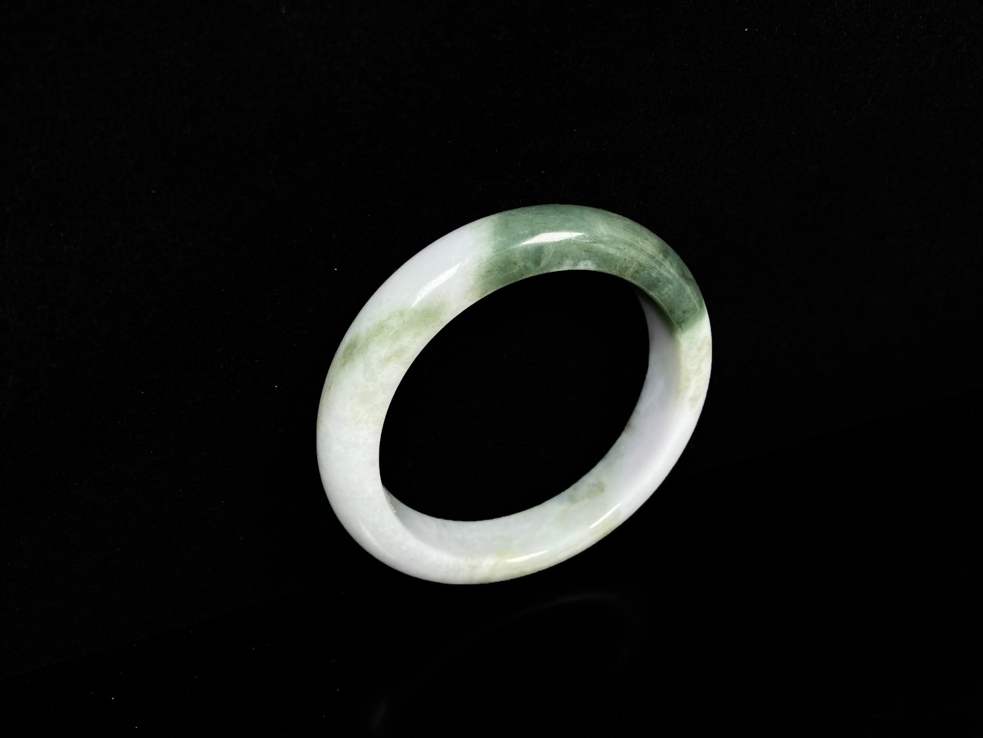A creamy white green  jadeite bangle.
