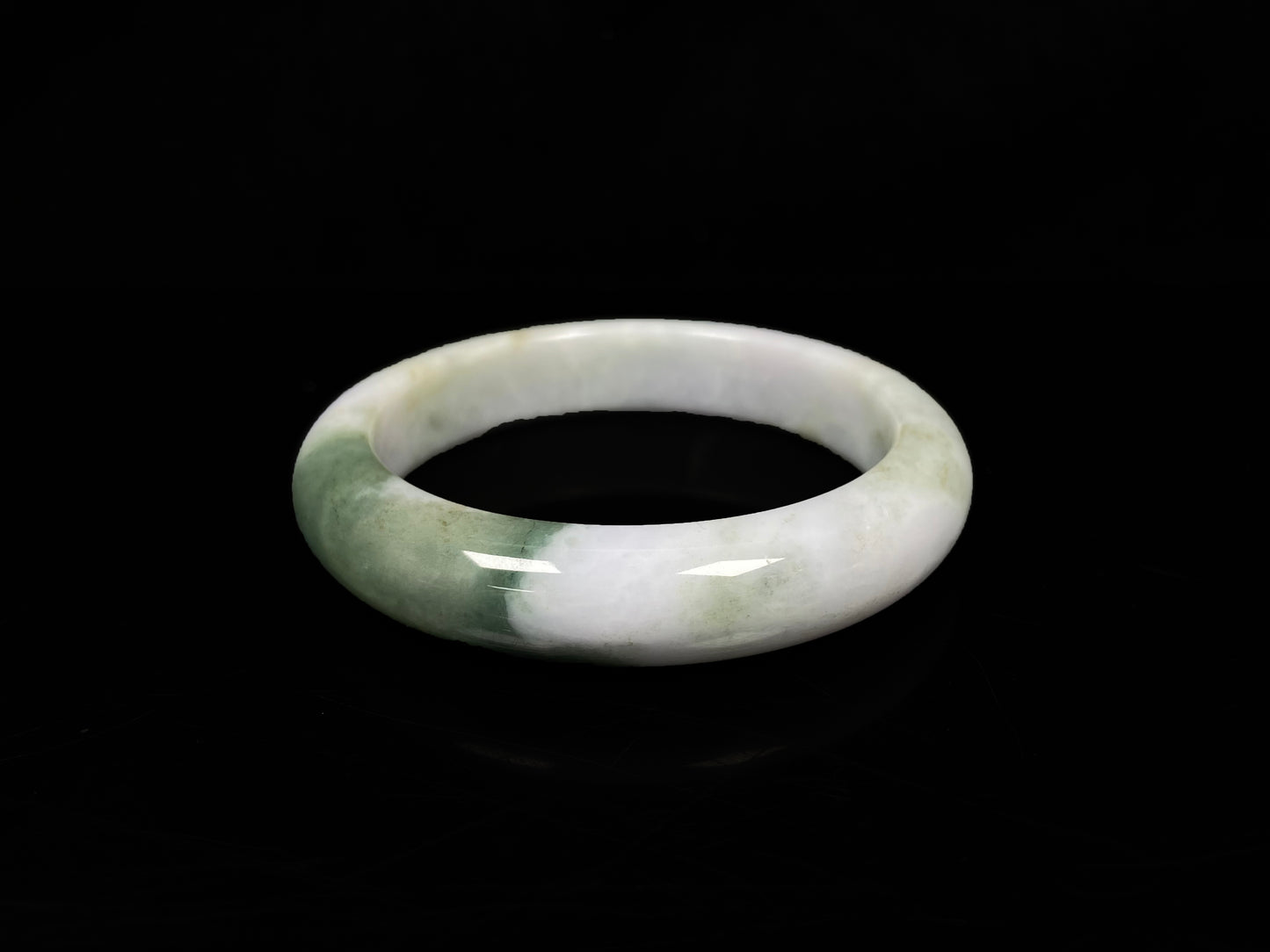 A creamy white green  jadeite bangle.