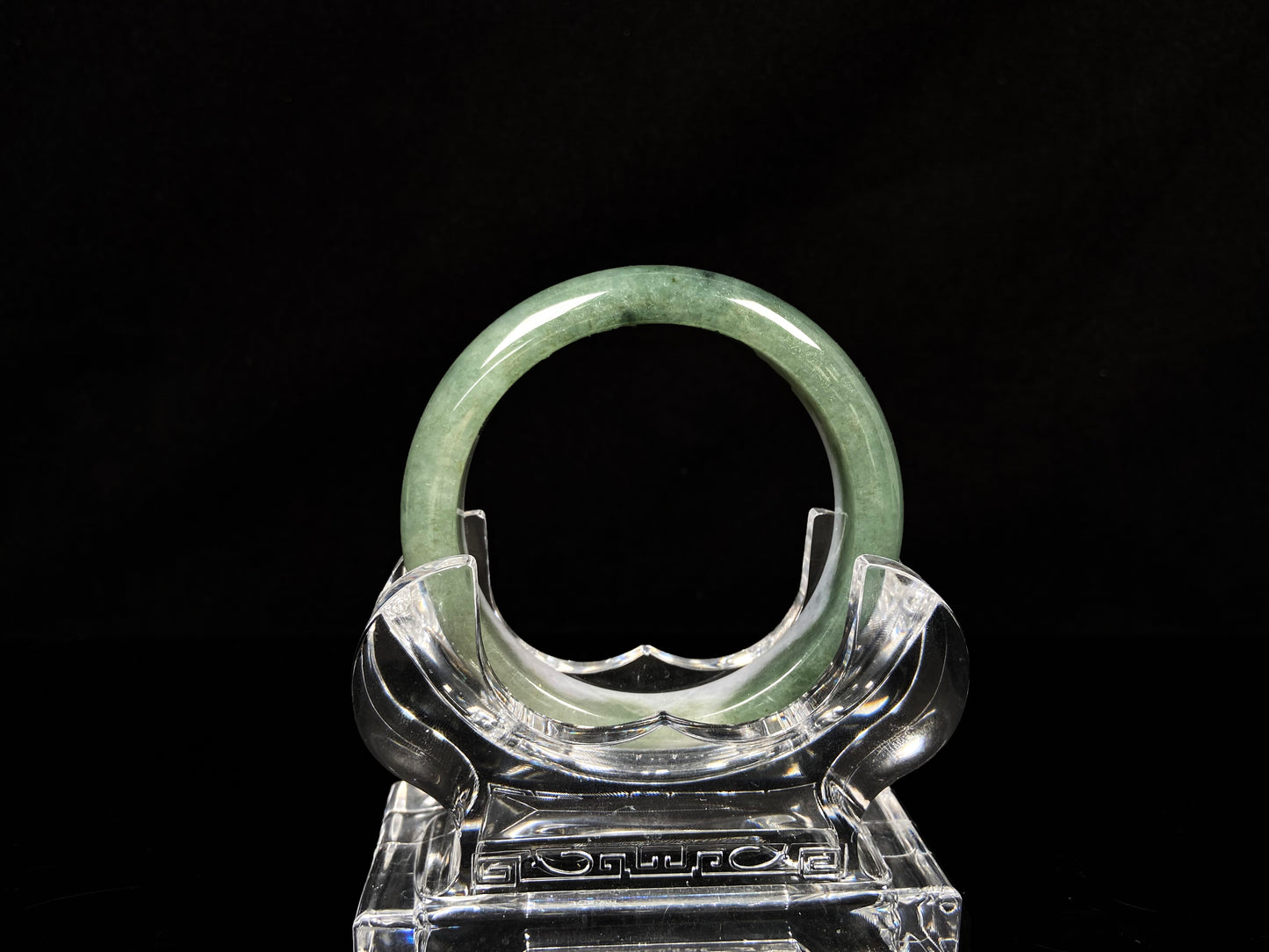 A oily deep green jadeite bangle.