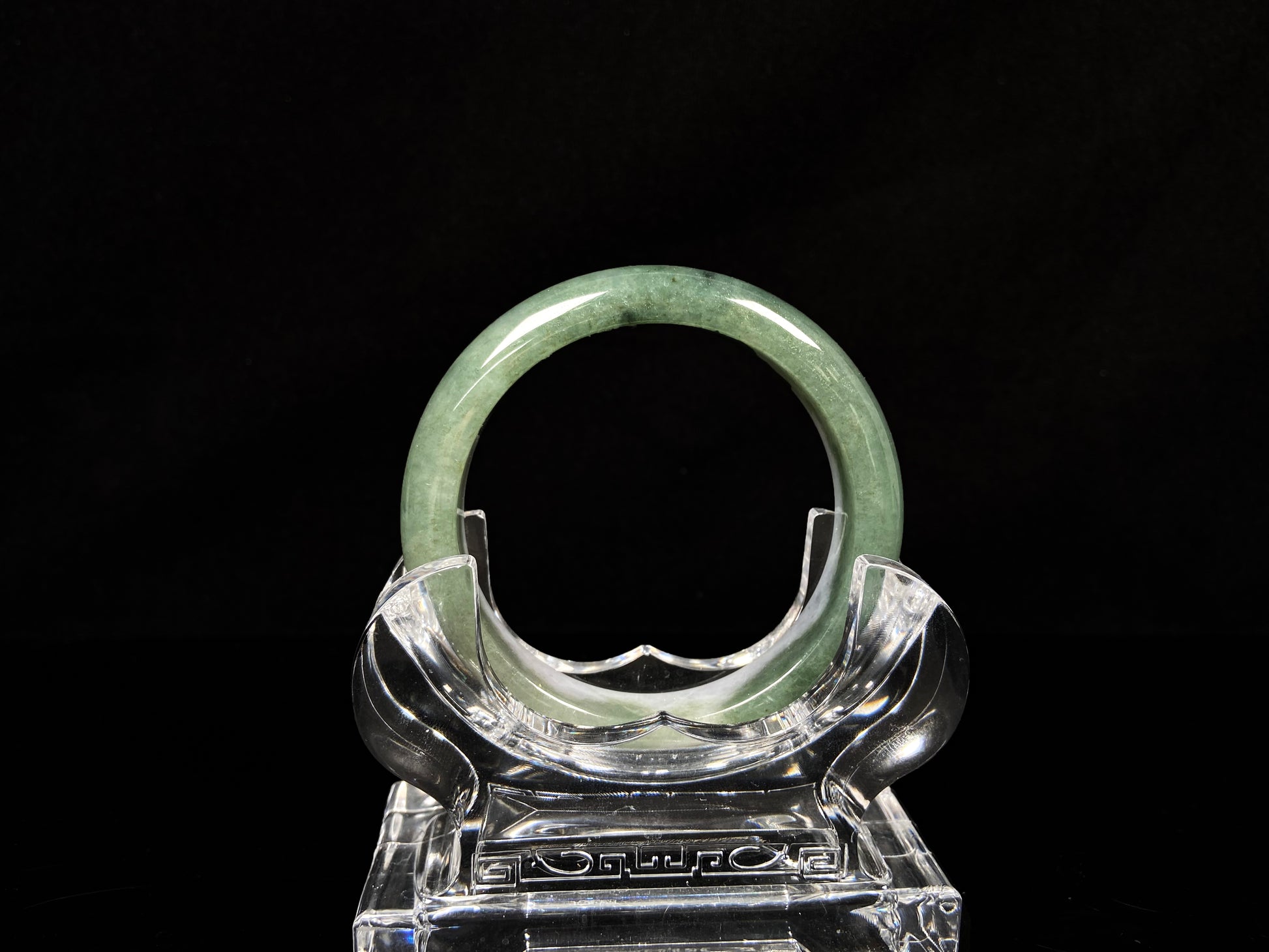 A oily deep green jadeite bangle.