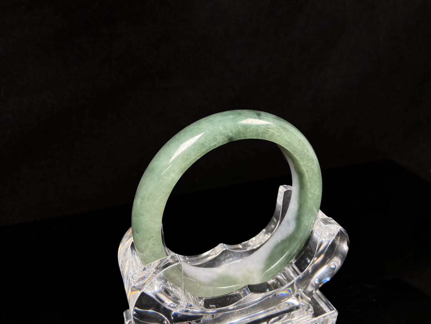 A oily deep green jadeite bangle.
