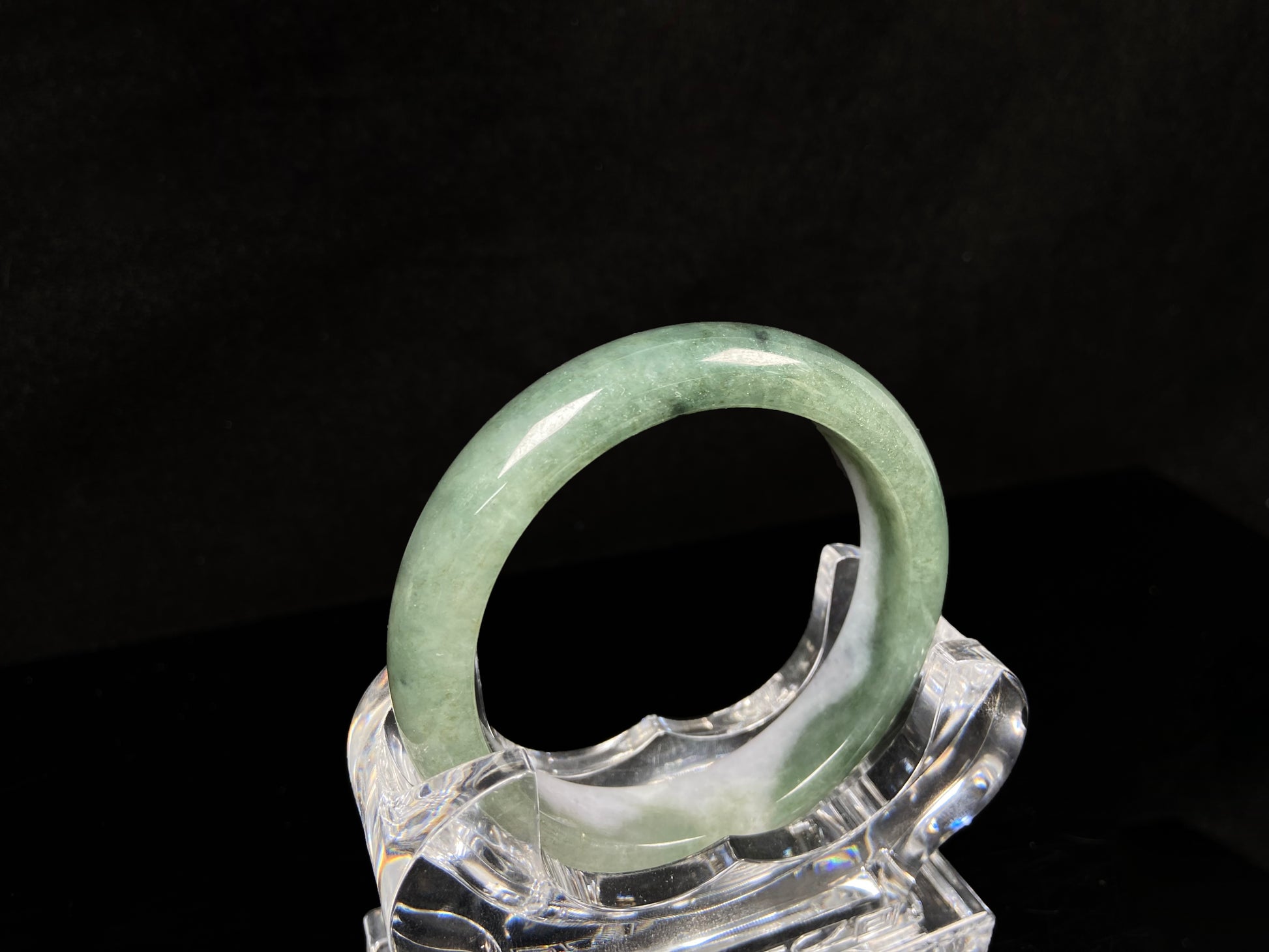 A oily deep green jadeite bangle.