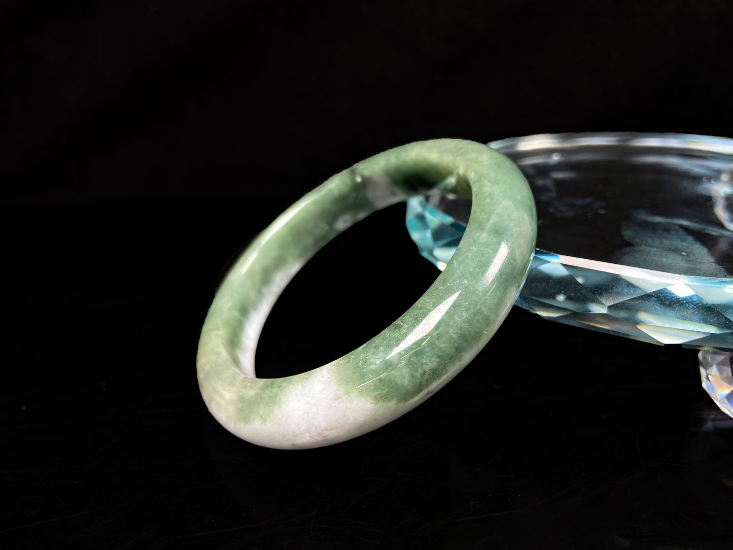 A oily deep green jadeite bangle.
