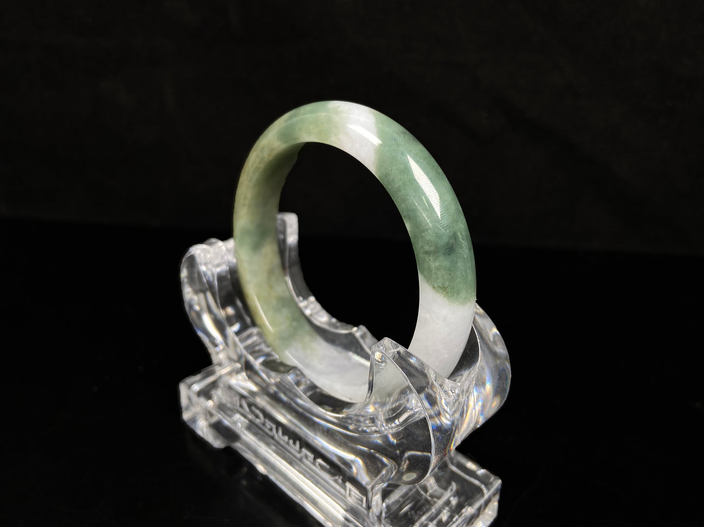 A verdant gold silken white  jadeite bangle.