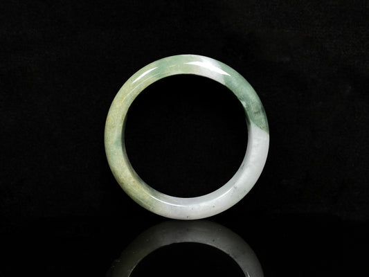 A verdant gold silken white  jadeite bangle.