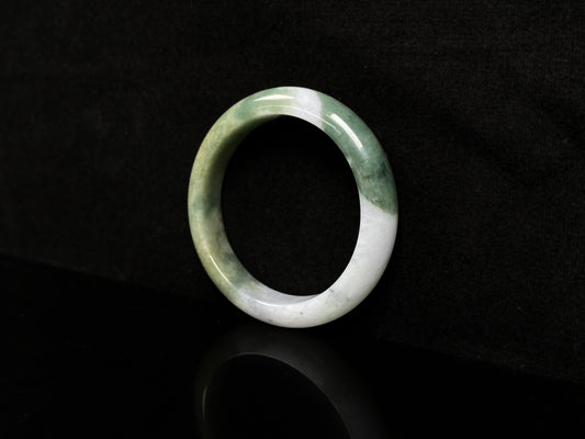A verdant gold silken white  jadeite bangle.