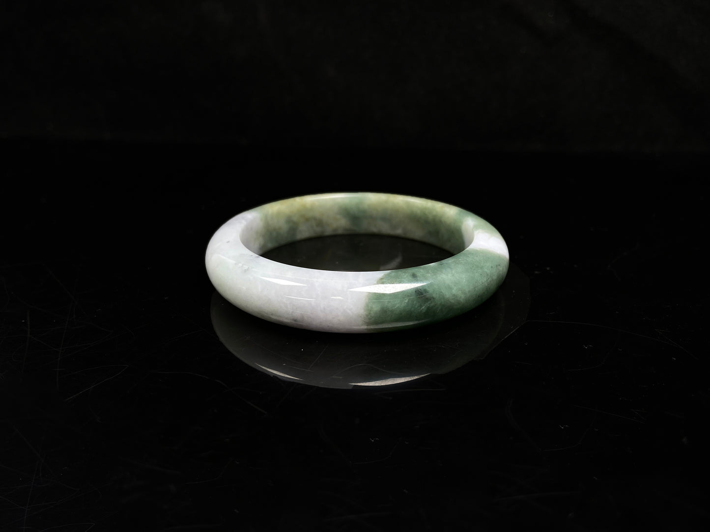 A verdant gold silken white  jadeite bangle.