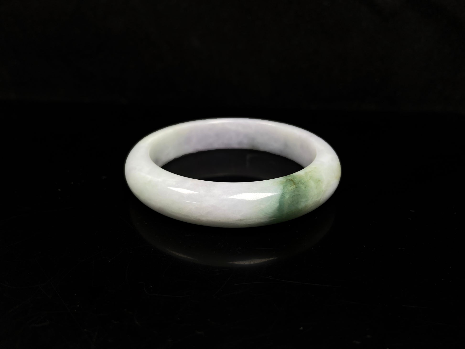 A pearl moss drift jadeite bangle.