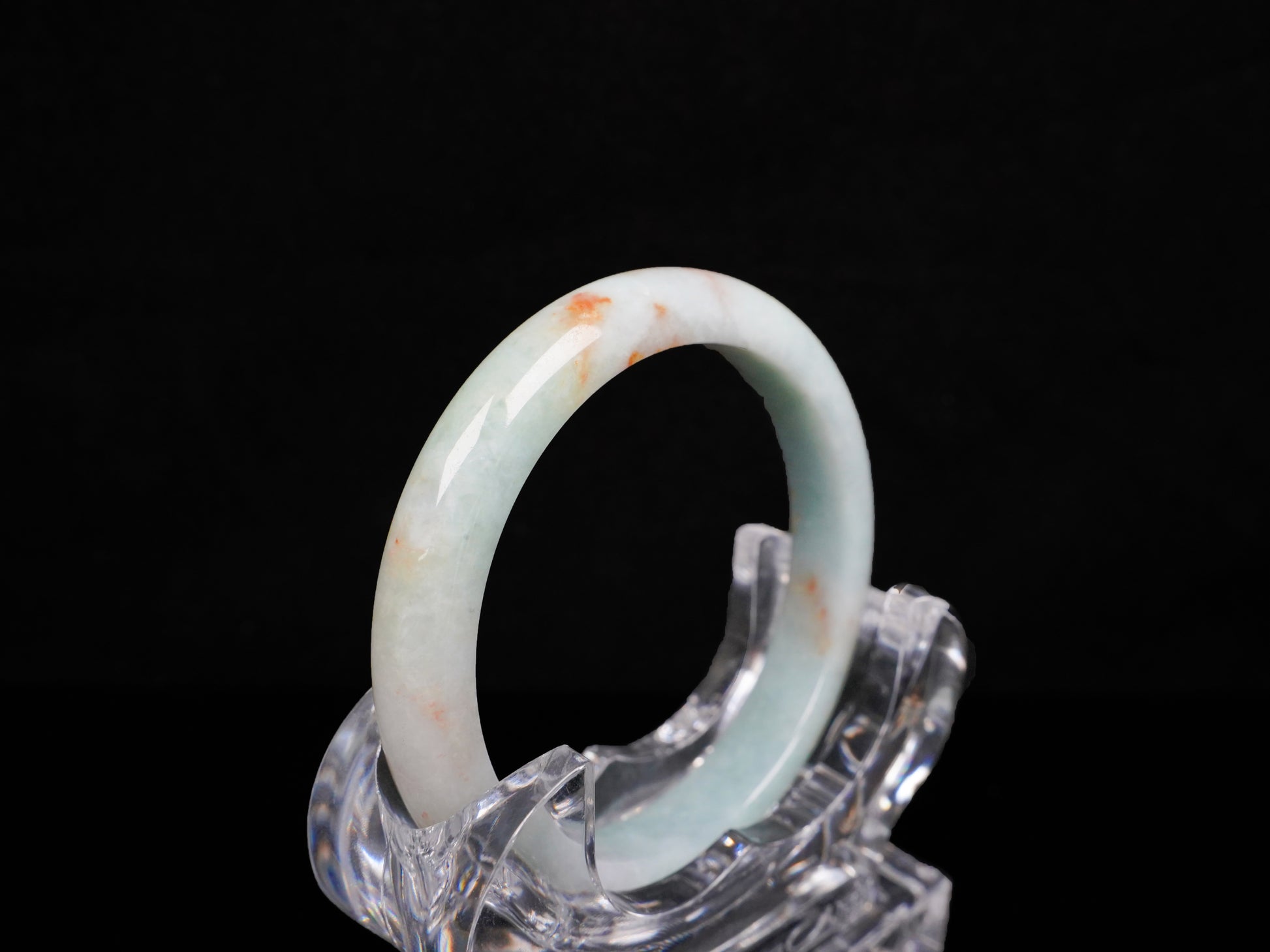 A coral glow veil jadeite bangle.