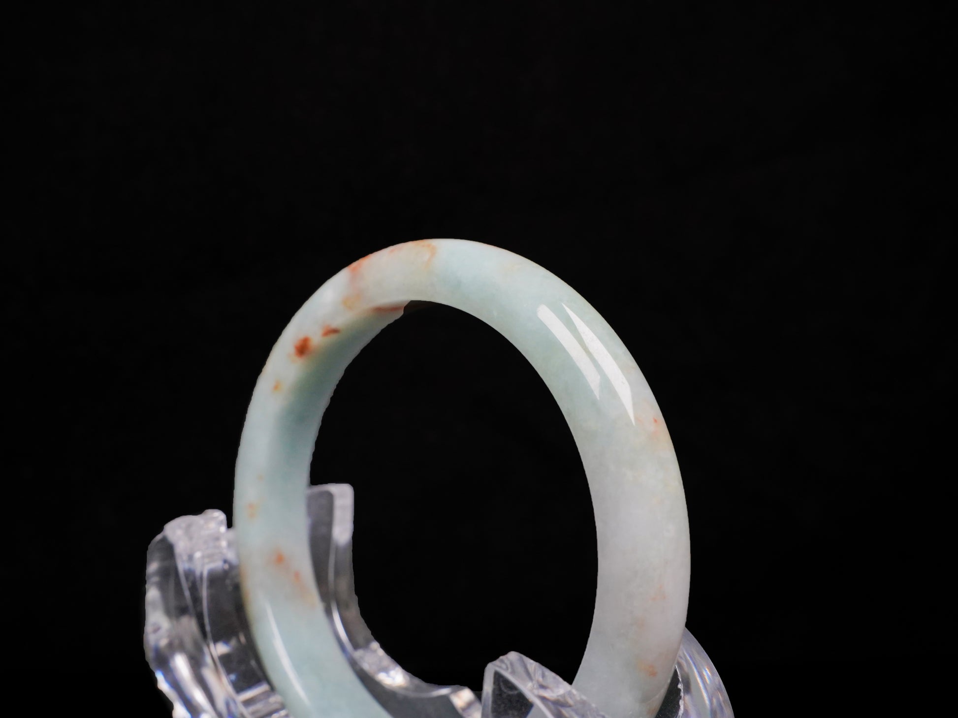 A coral glow veil jadeite bangle.