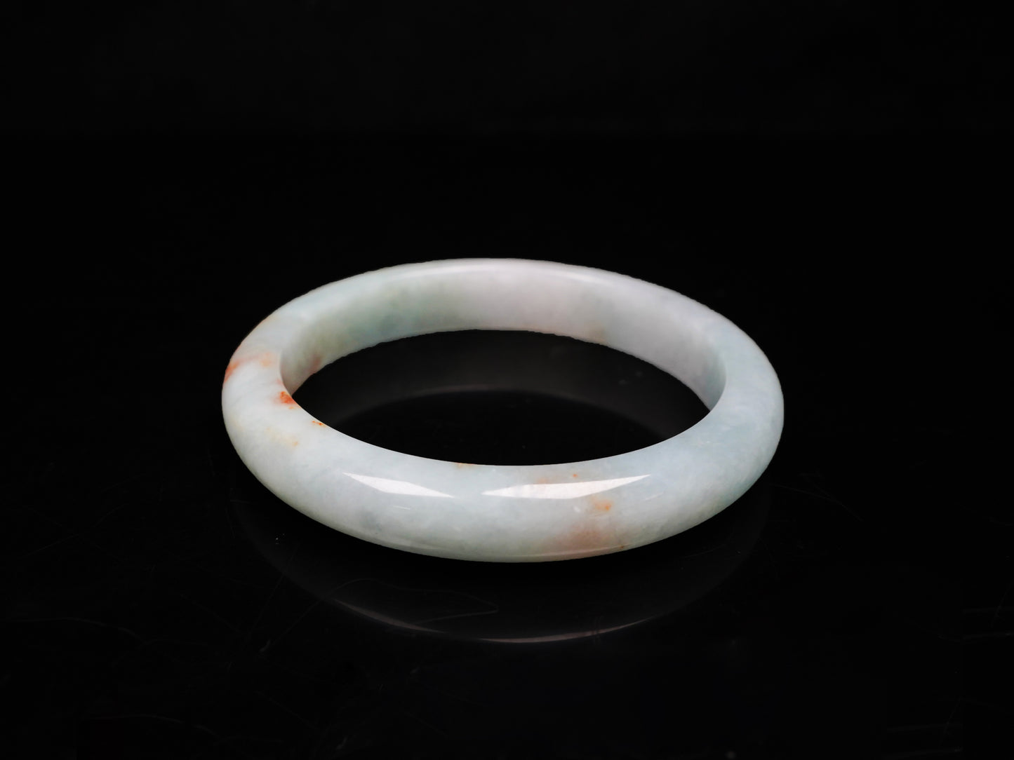 A coral glow veil jadeite bangle.