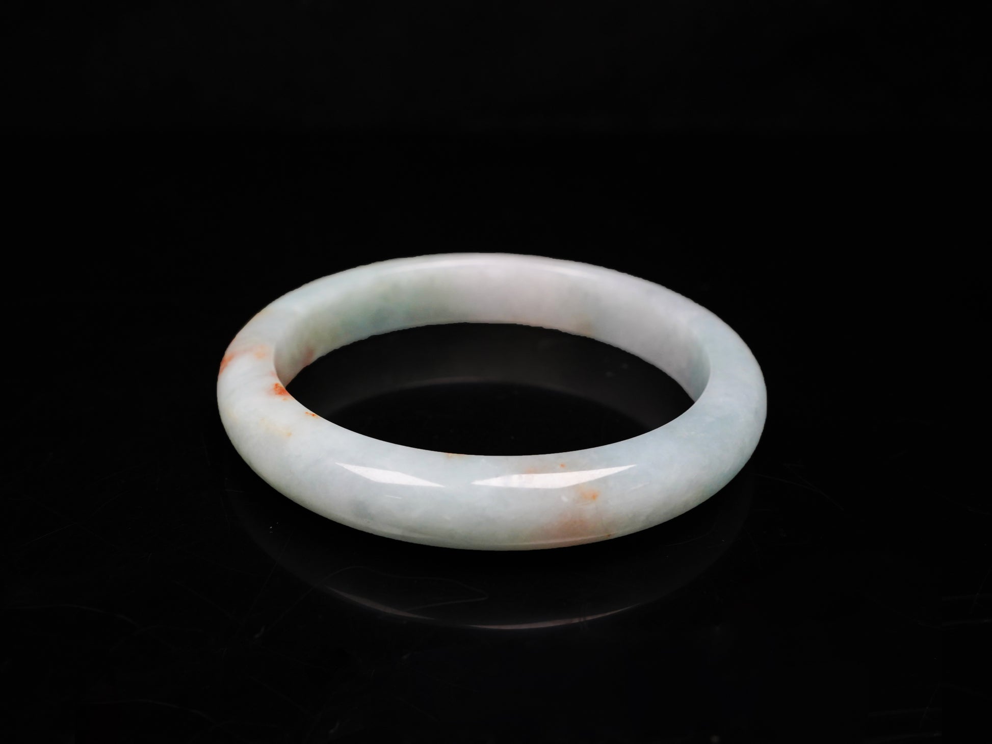 A coral glow veil jadeite bangle.