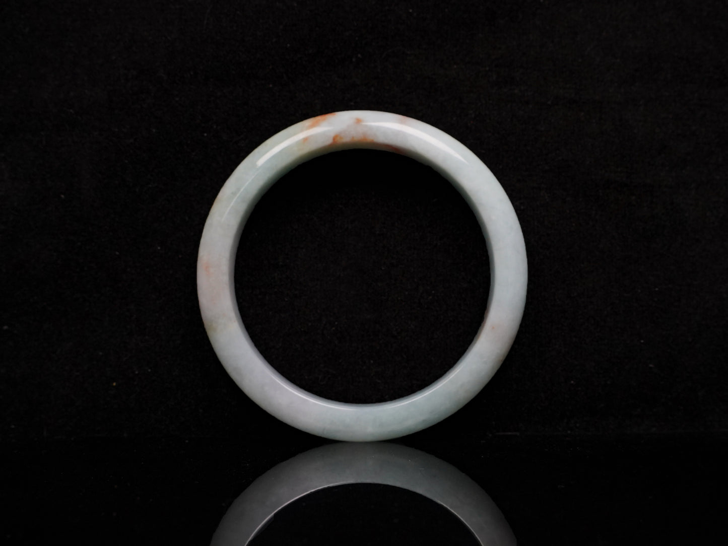 A coral glow veil jadeite bangle.
