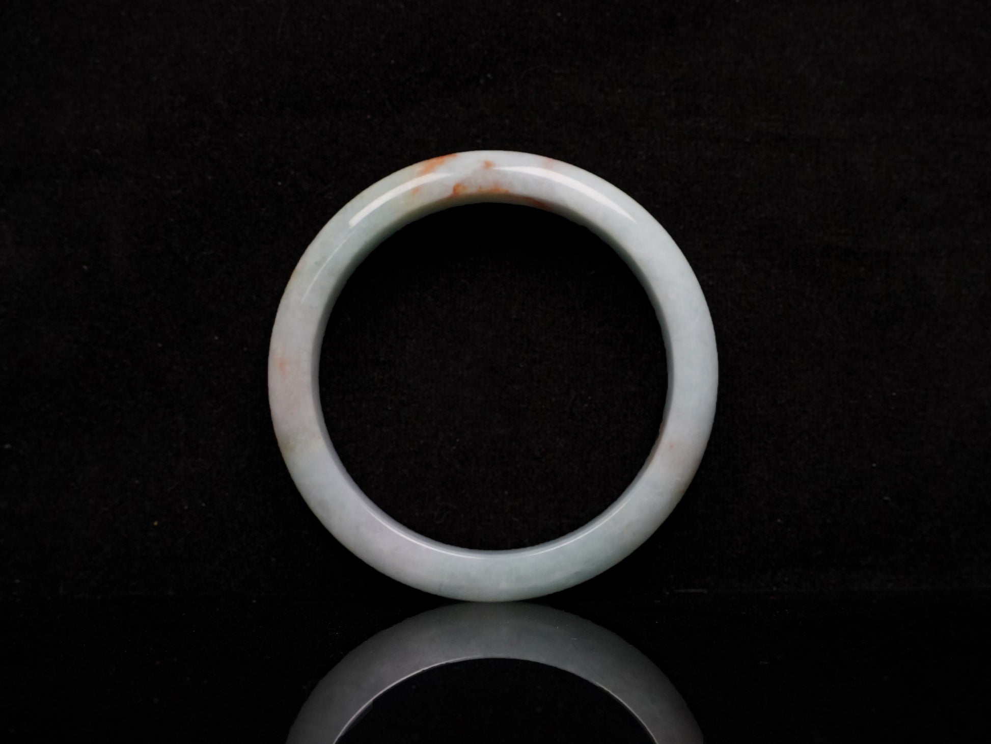 A coral glow veil jadeite bangle.