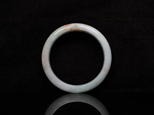 A coral glow veil jadeite bangle.