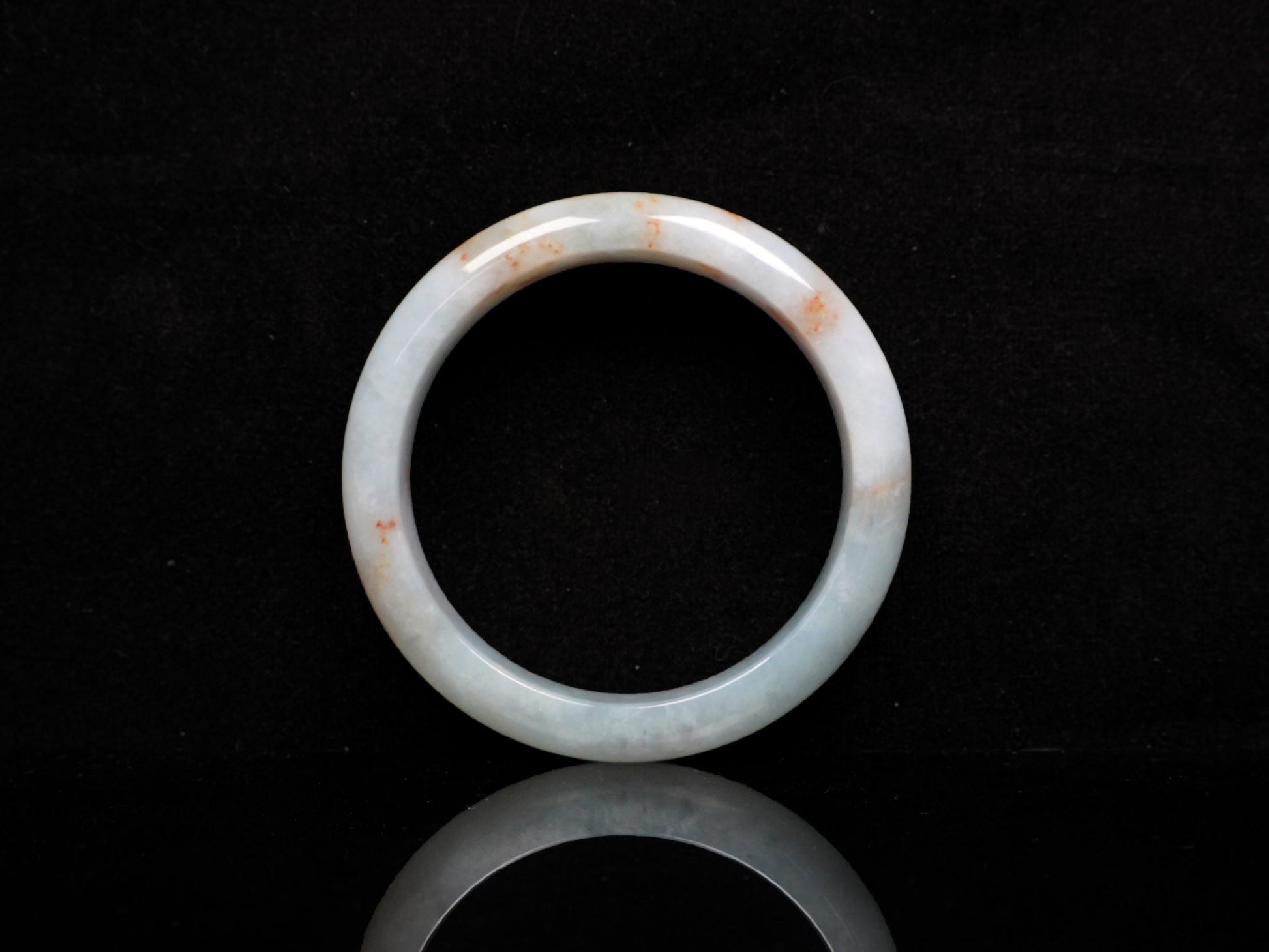 A red speckle green base  jadeite bangle.