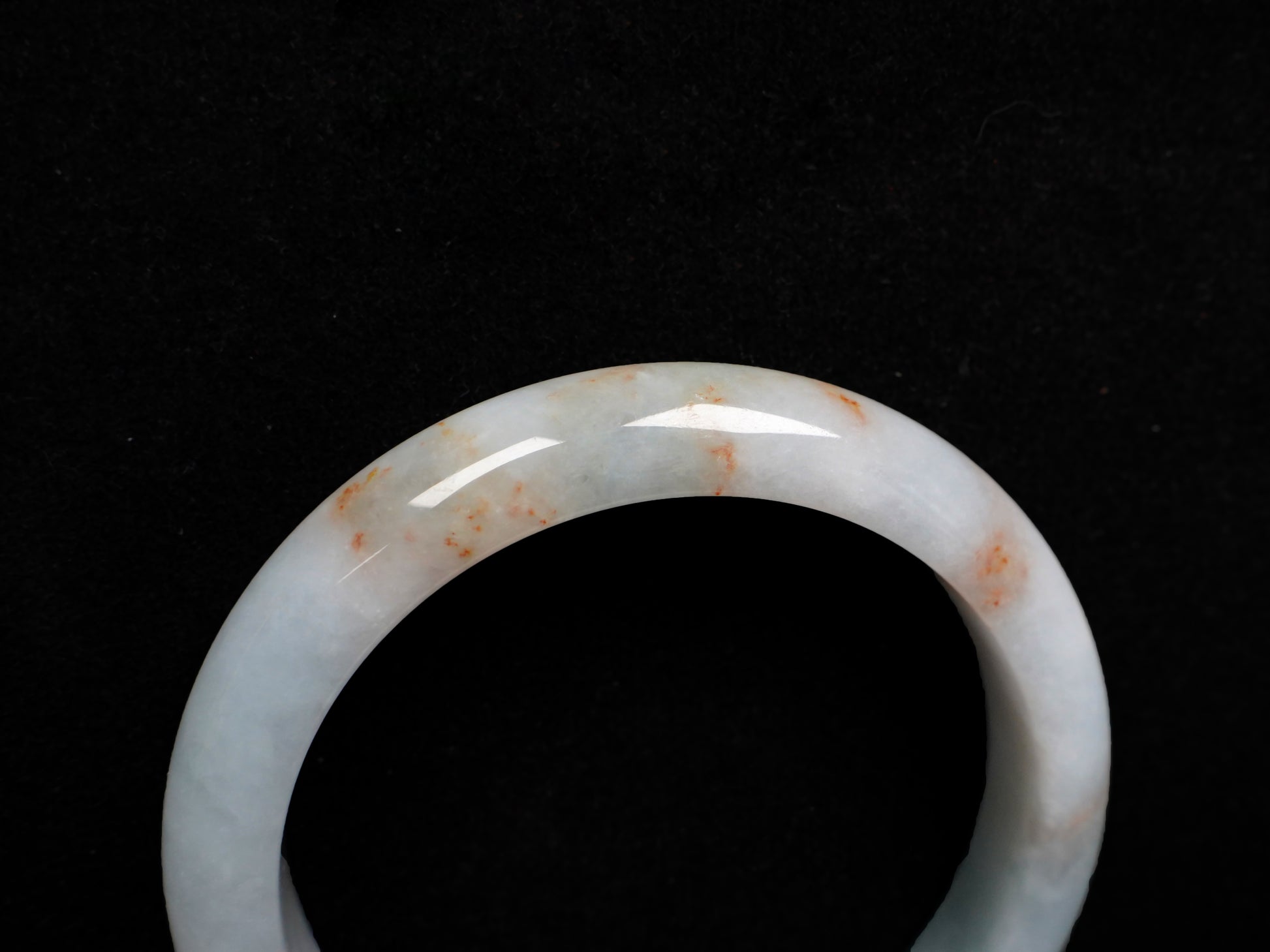 A red speckle green base  jadeite bangle.