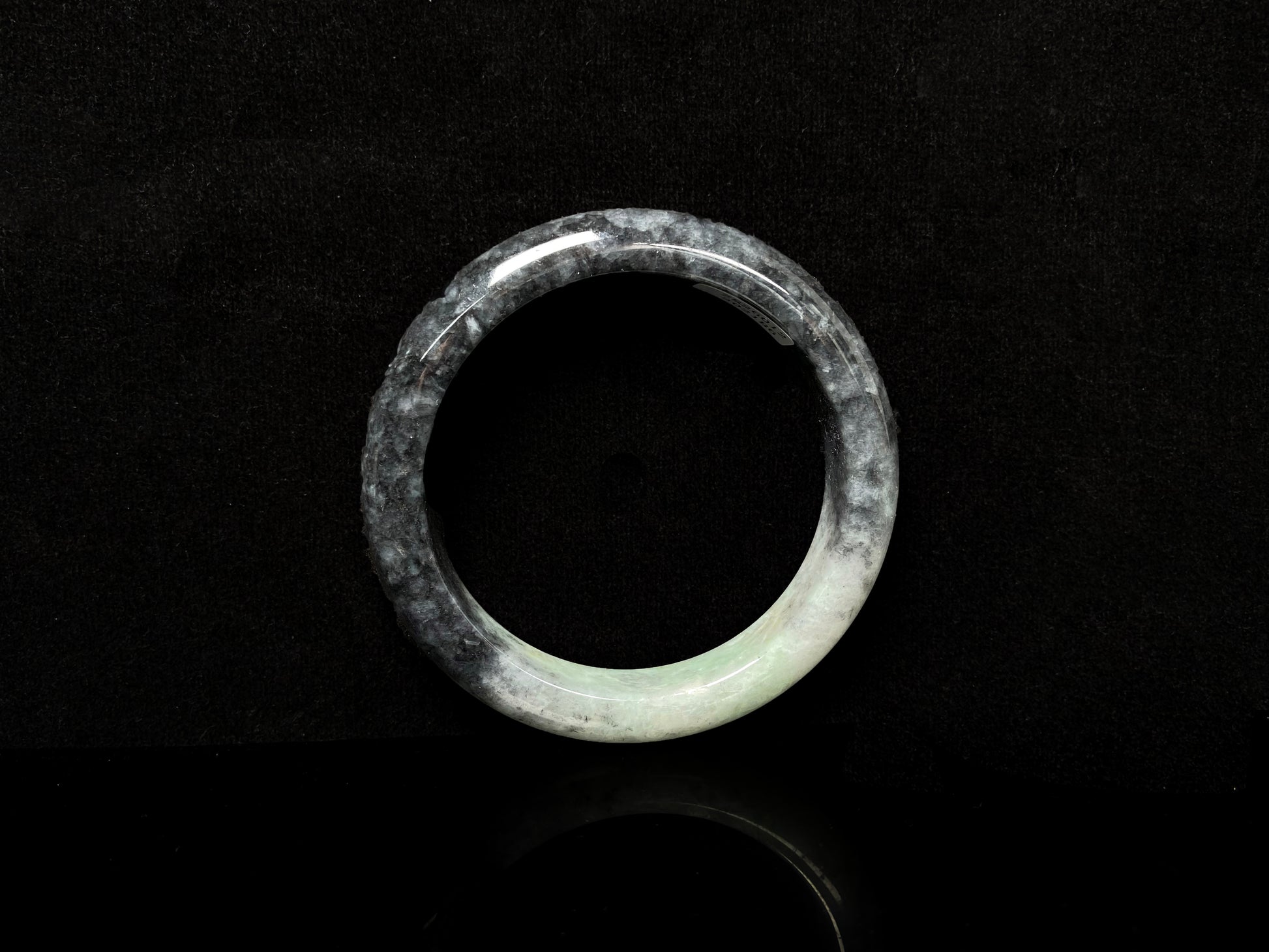 A white black jadeite bangle.