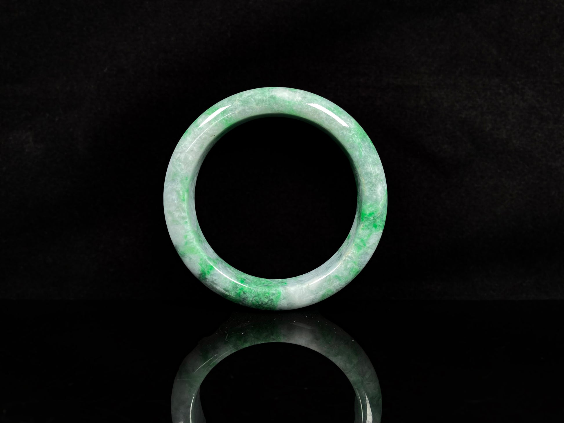 A white-base green-pattern jadeite bangles.