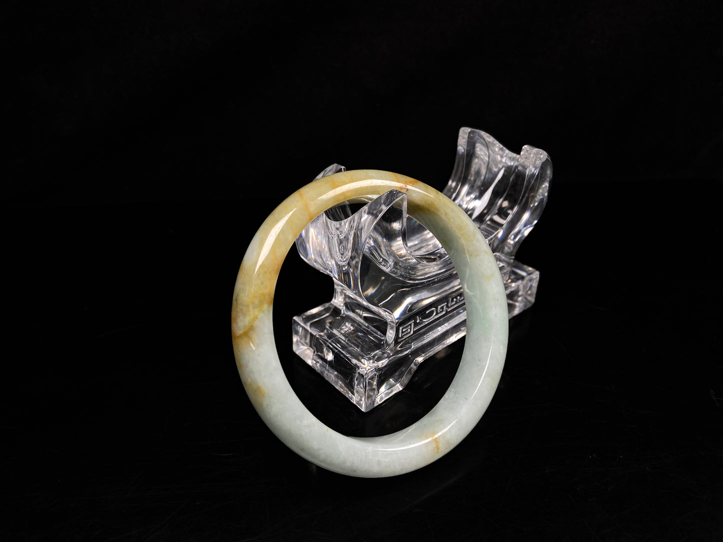 A soft celadon with amber swirls jadeite bangle.