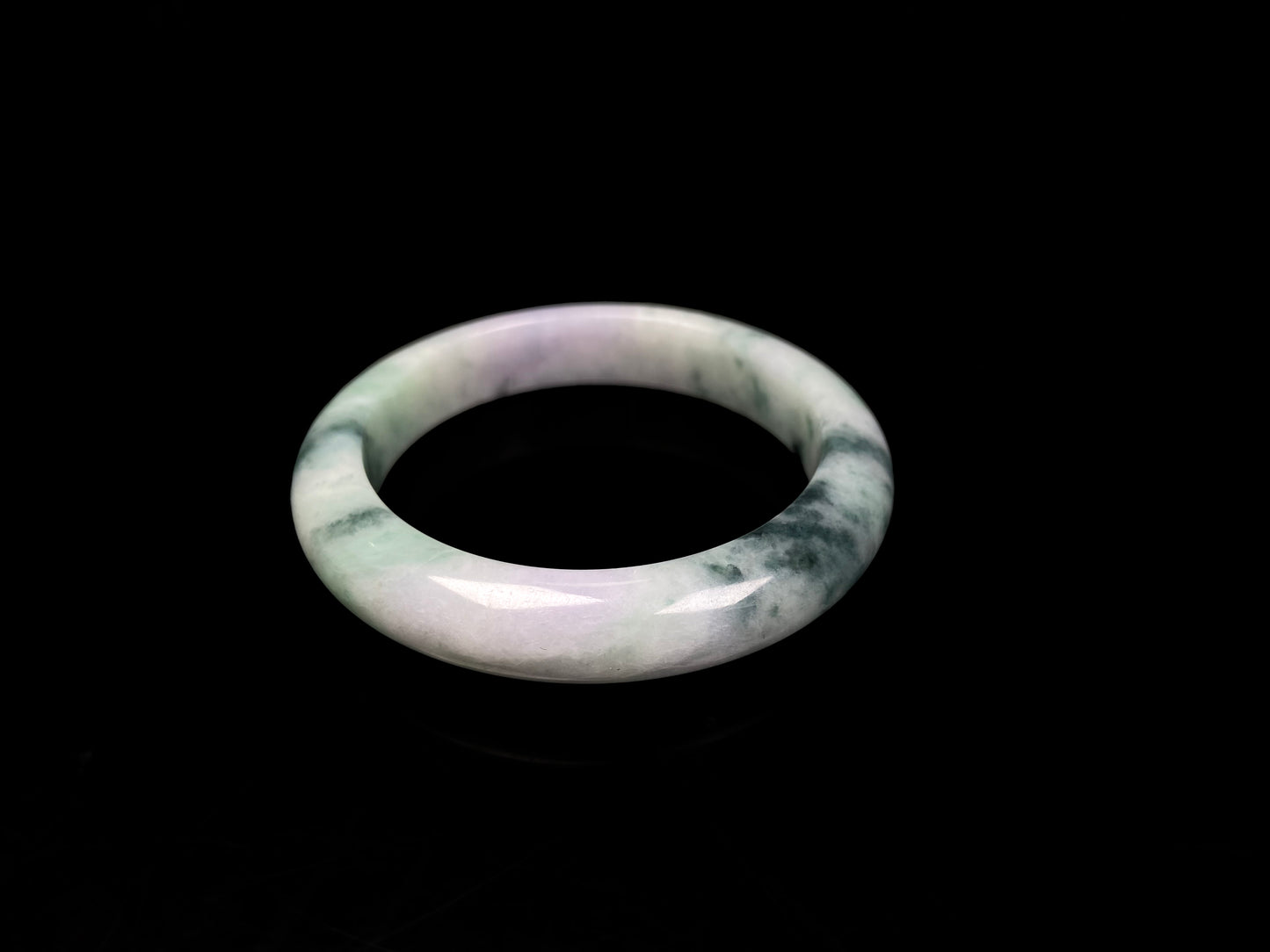 A misty green lavender jadeite bangle.