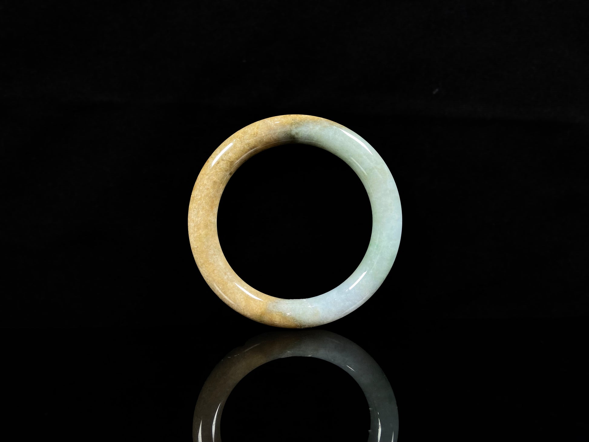 A golden sand and green mist jadeite bangle.