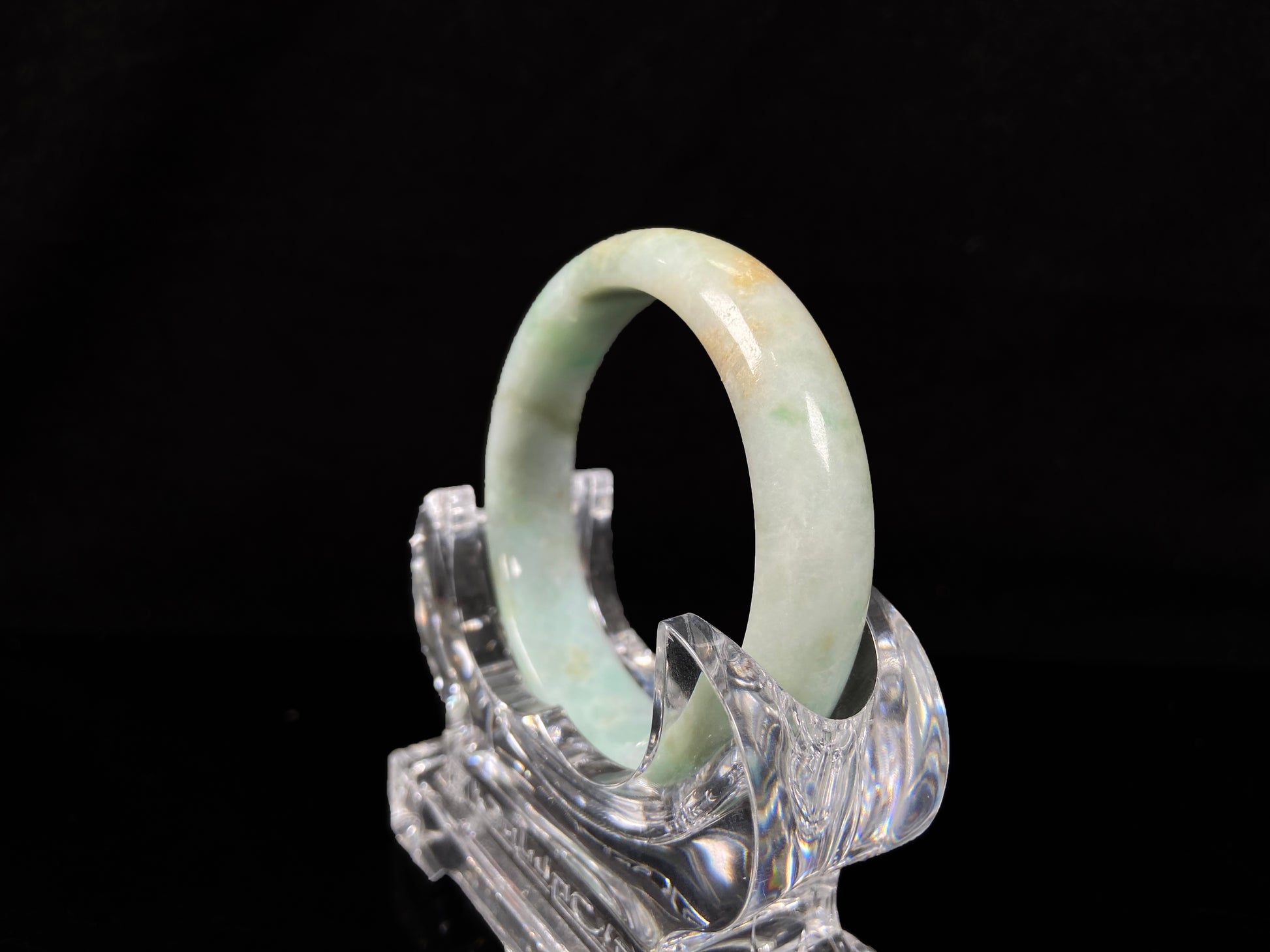 A moss honey jadeite bangle.