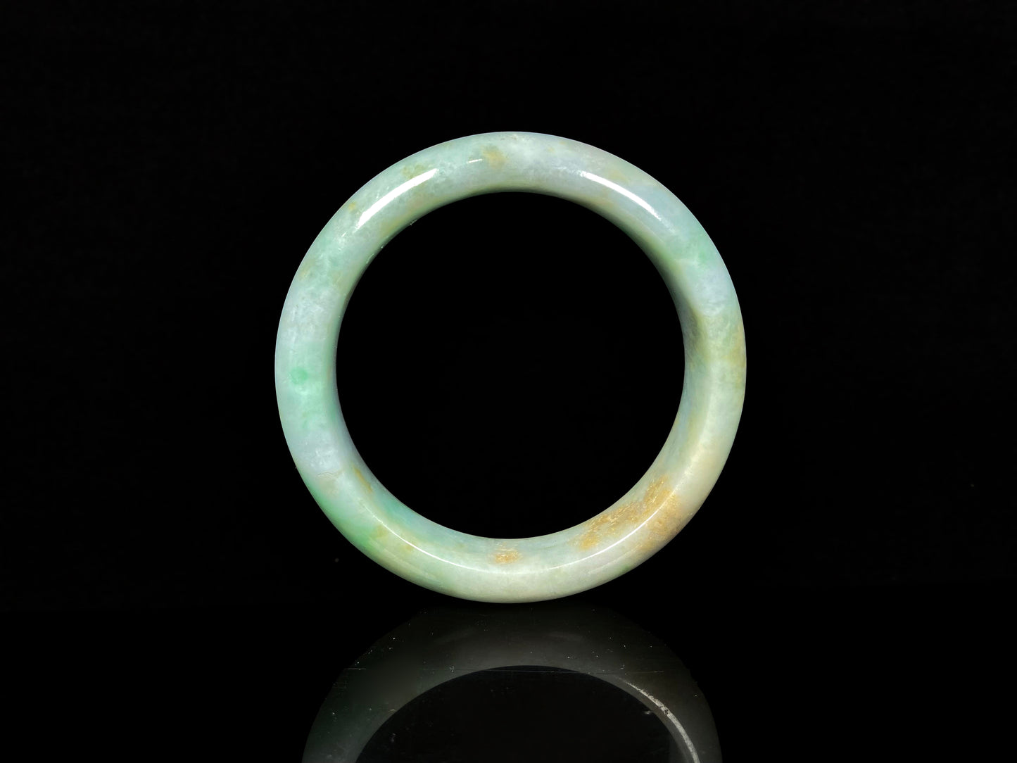 A moss honey jadeite bangle.