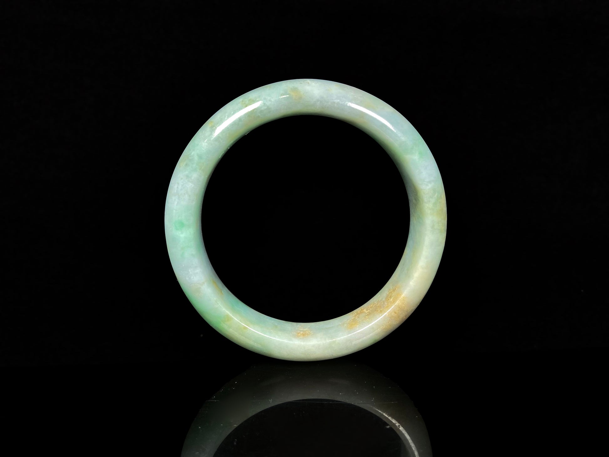 A moss honey jadeite bangle.