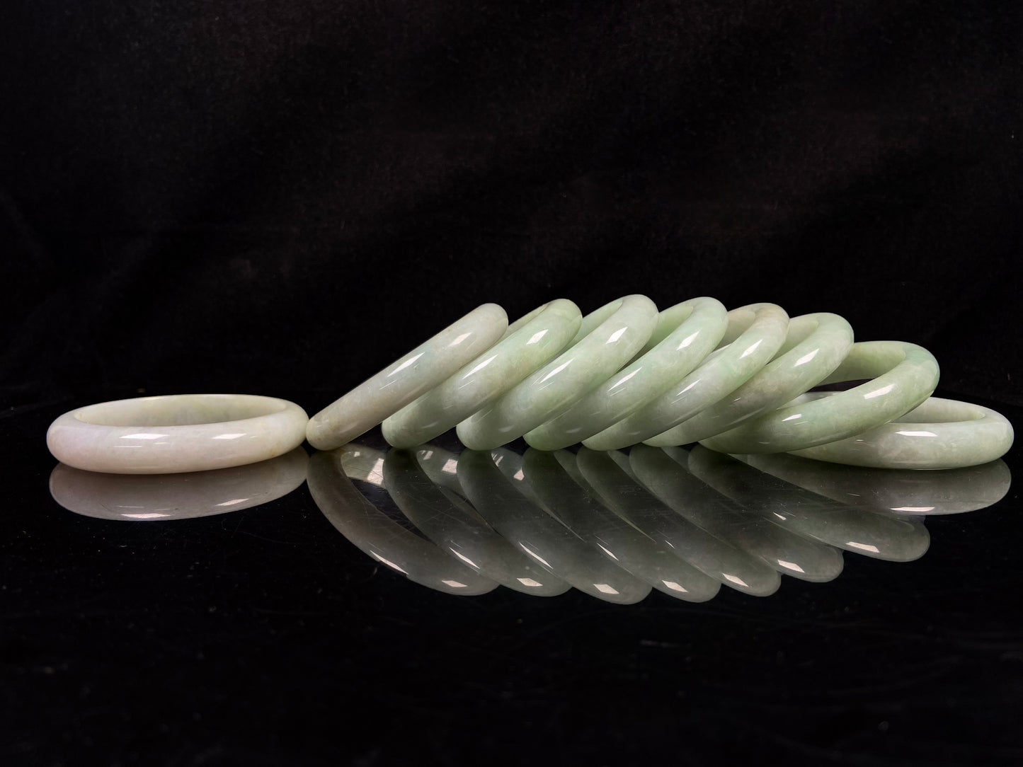 A willow bud green glow jadeite bangle group.