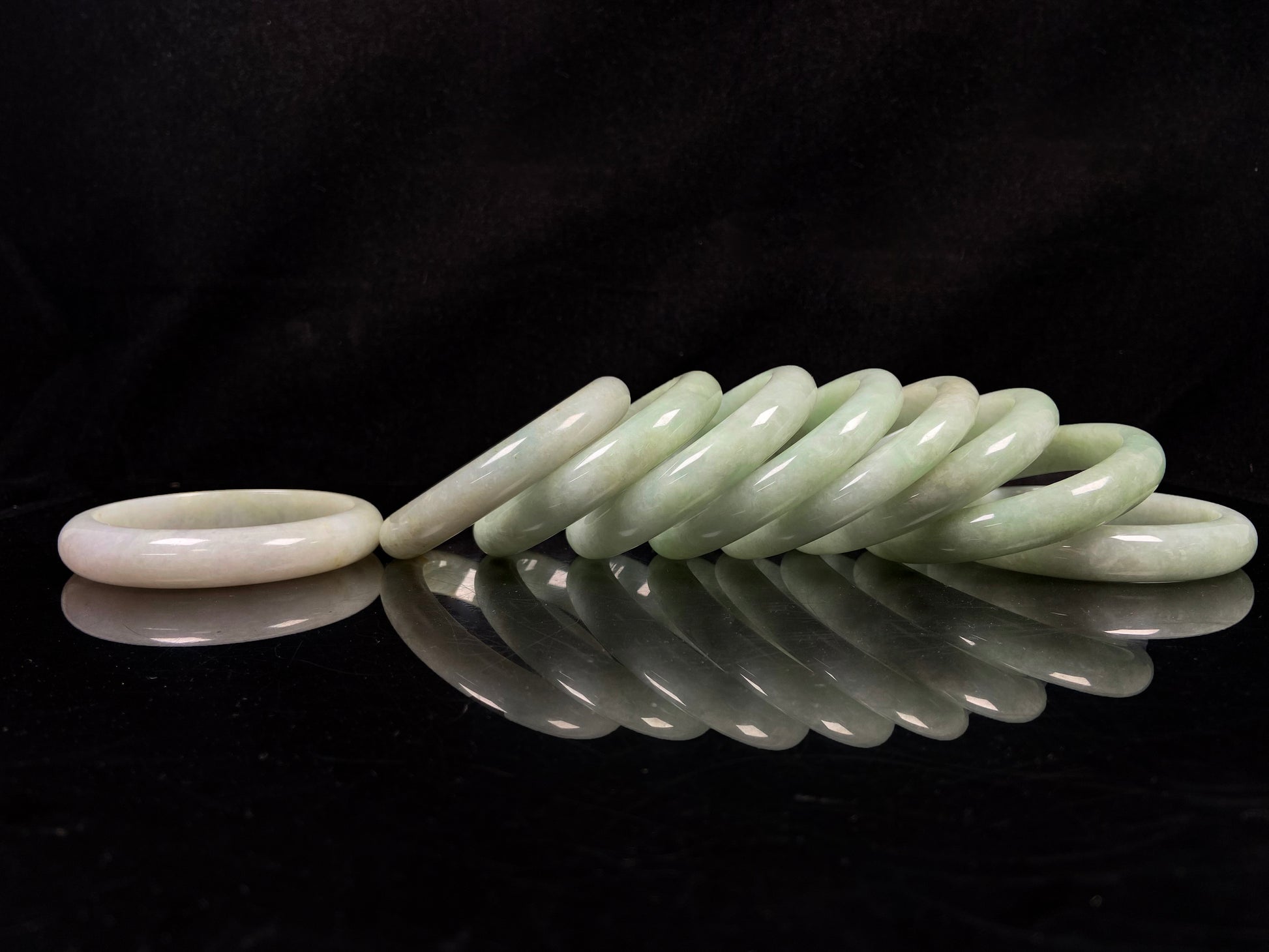 A willow bud green glow jadeite bangle group.