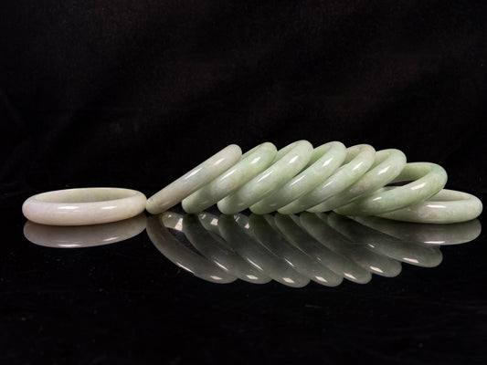 A willow bud green glow jadeite bangle group.