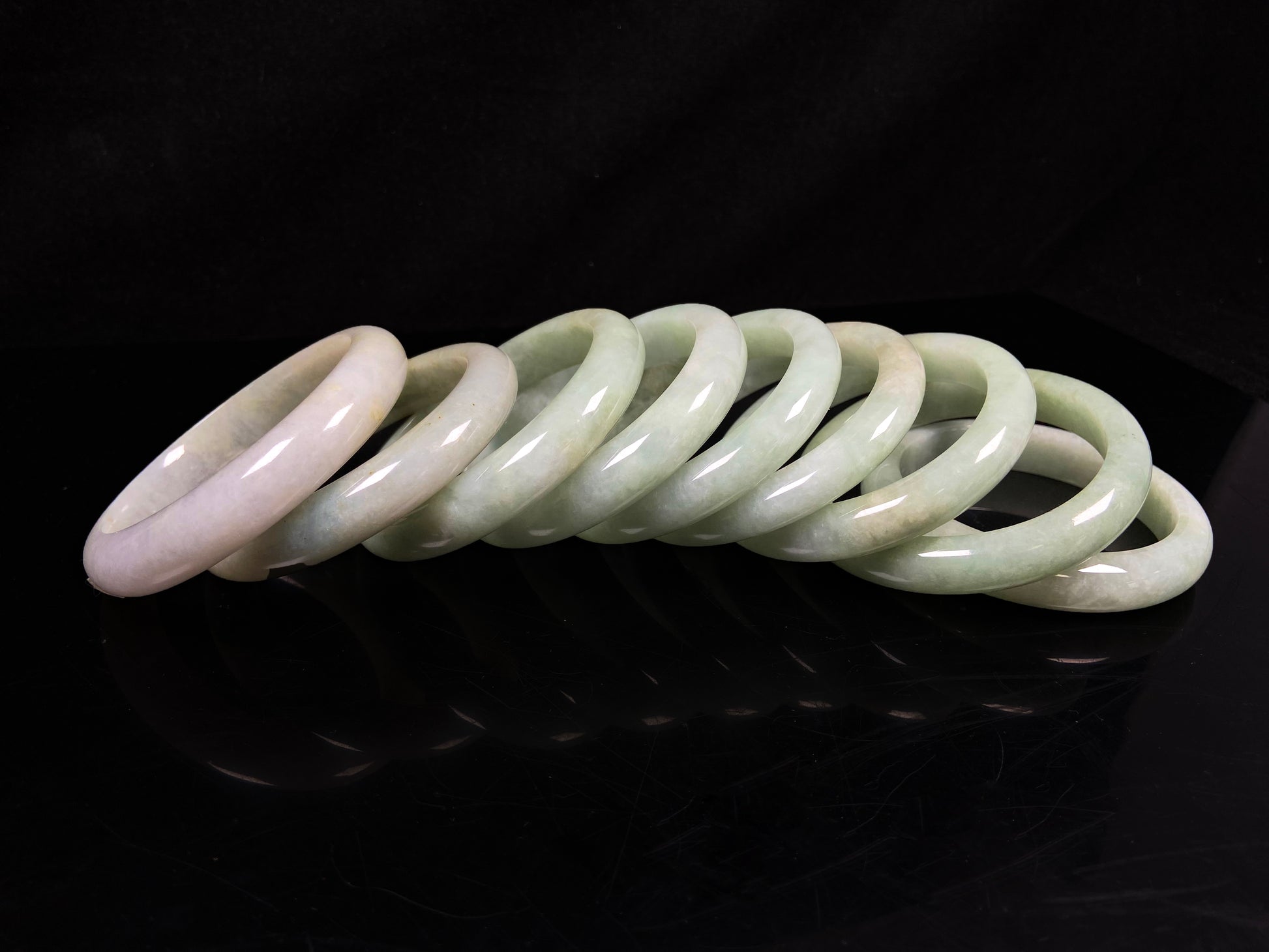 A willow bud green glow jadeite bangle group.