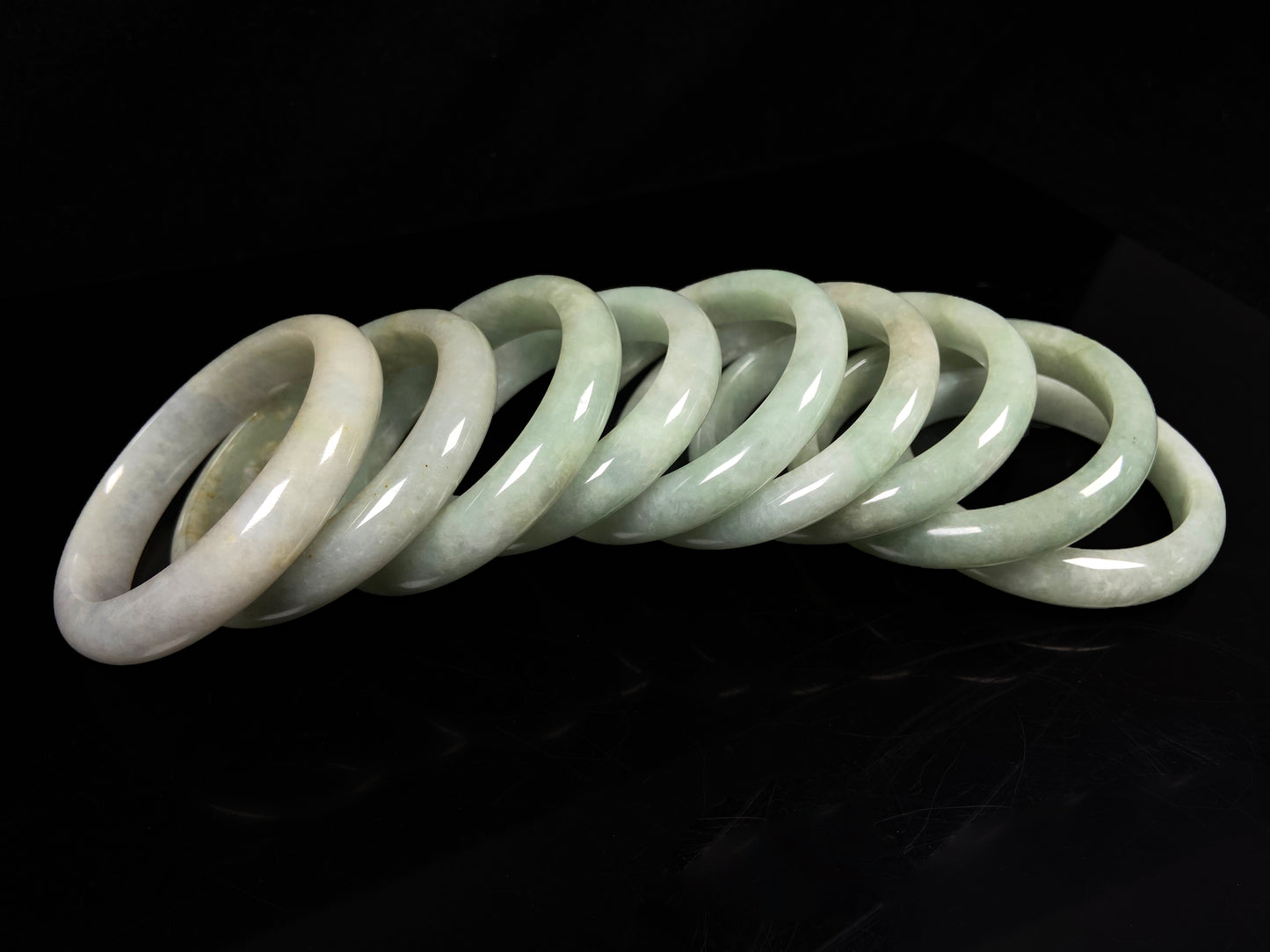 A willow bud green glow jadeite bangle group.