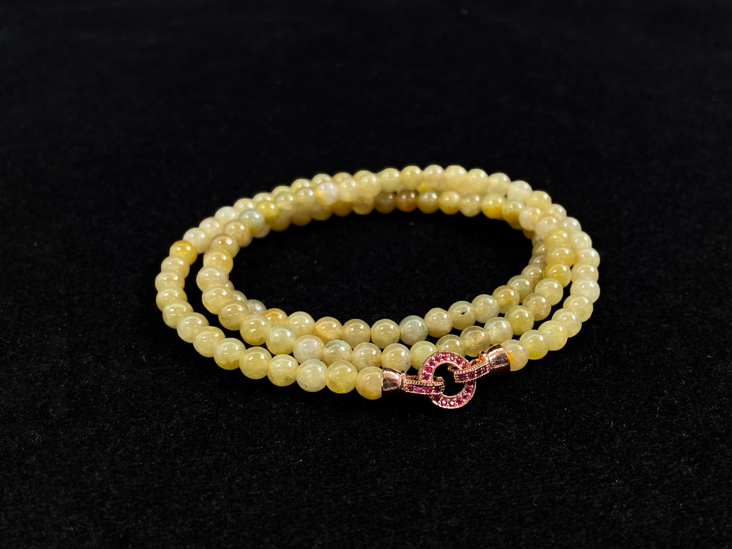 A semi transparent yellow jade bead strand connected by alloy end caps.