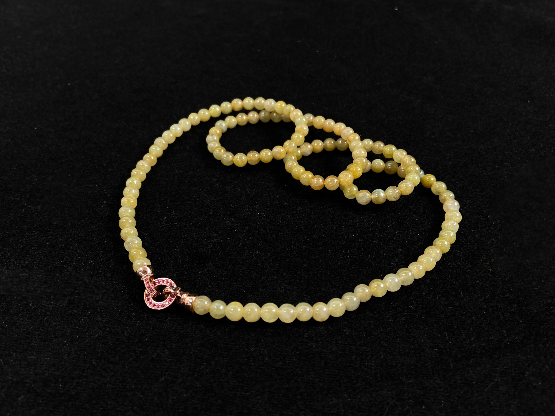 A semi transparent yellow jade bead strand connected by alloy end caps.