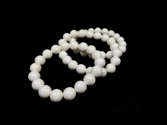 A porcelain white smooth bead ceramic beaded bracelet.