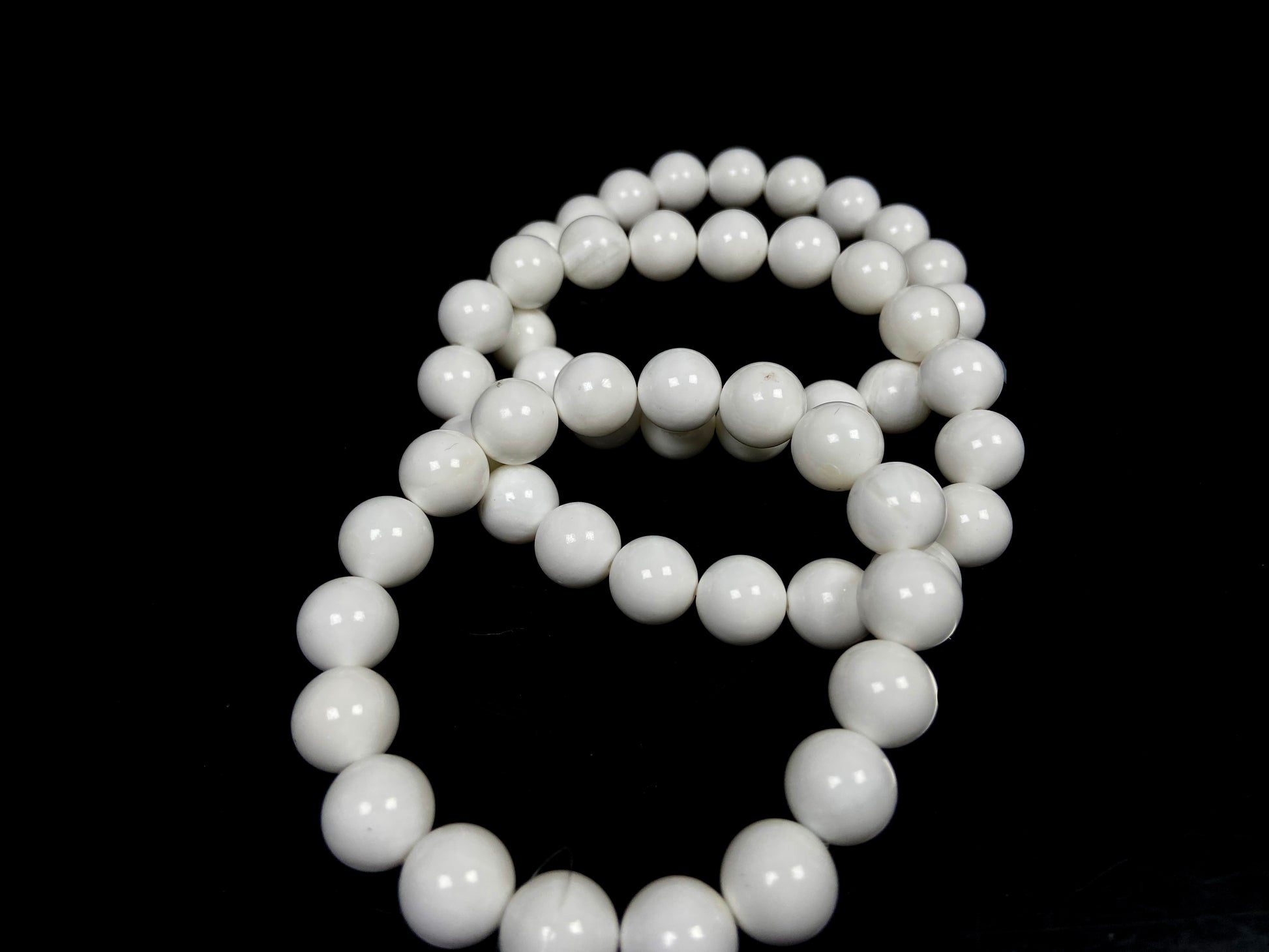 A porcelain white smooth bead ceramic beaded bracelet.